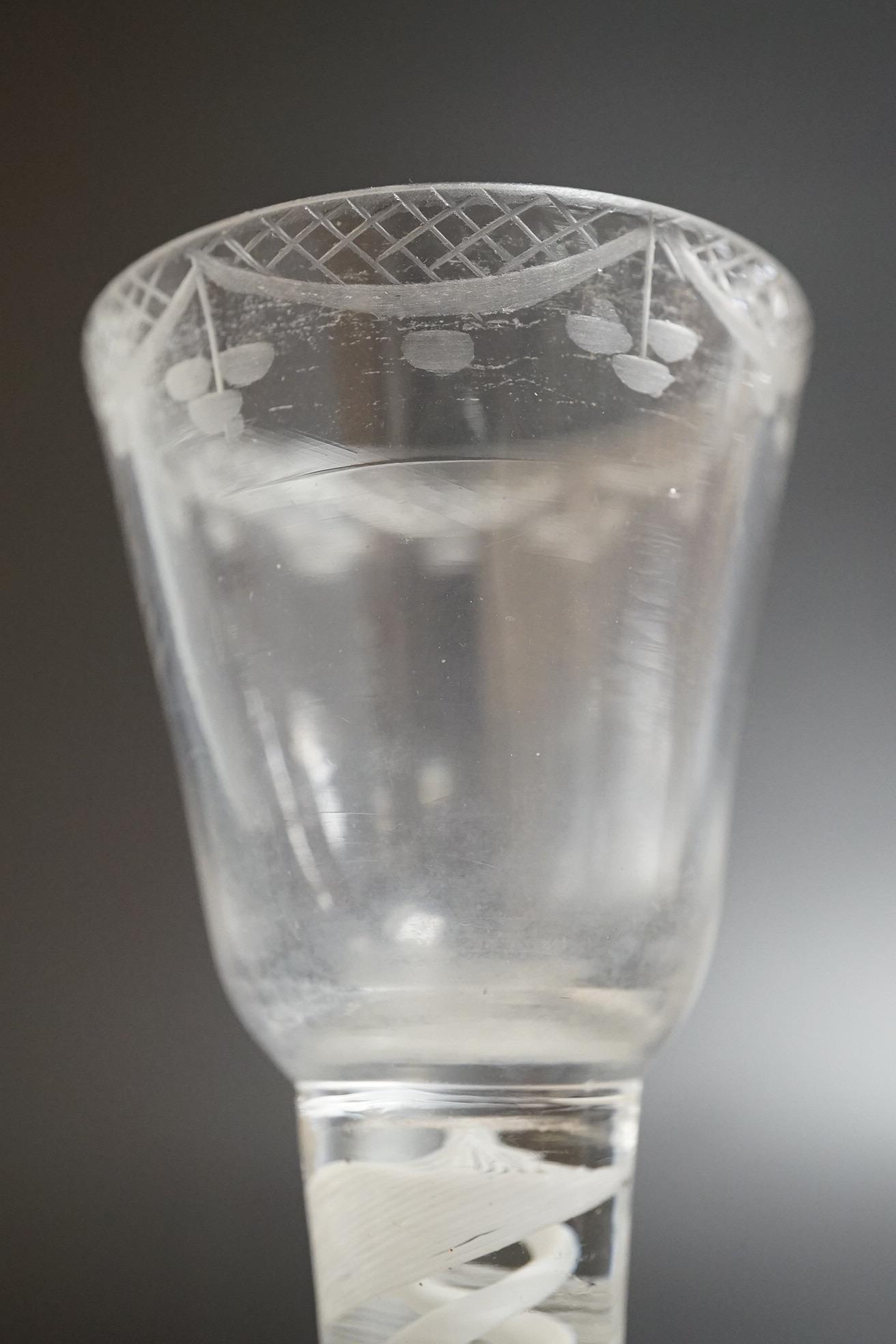 An opaque twist firing glass with terraced foot and a faceted wine glass with domed foot, c.1760, tallest 14cm